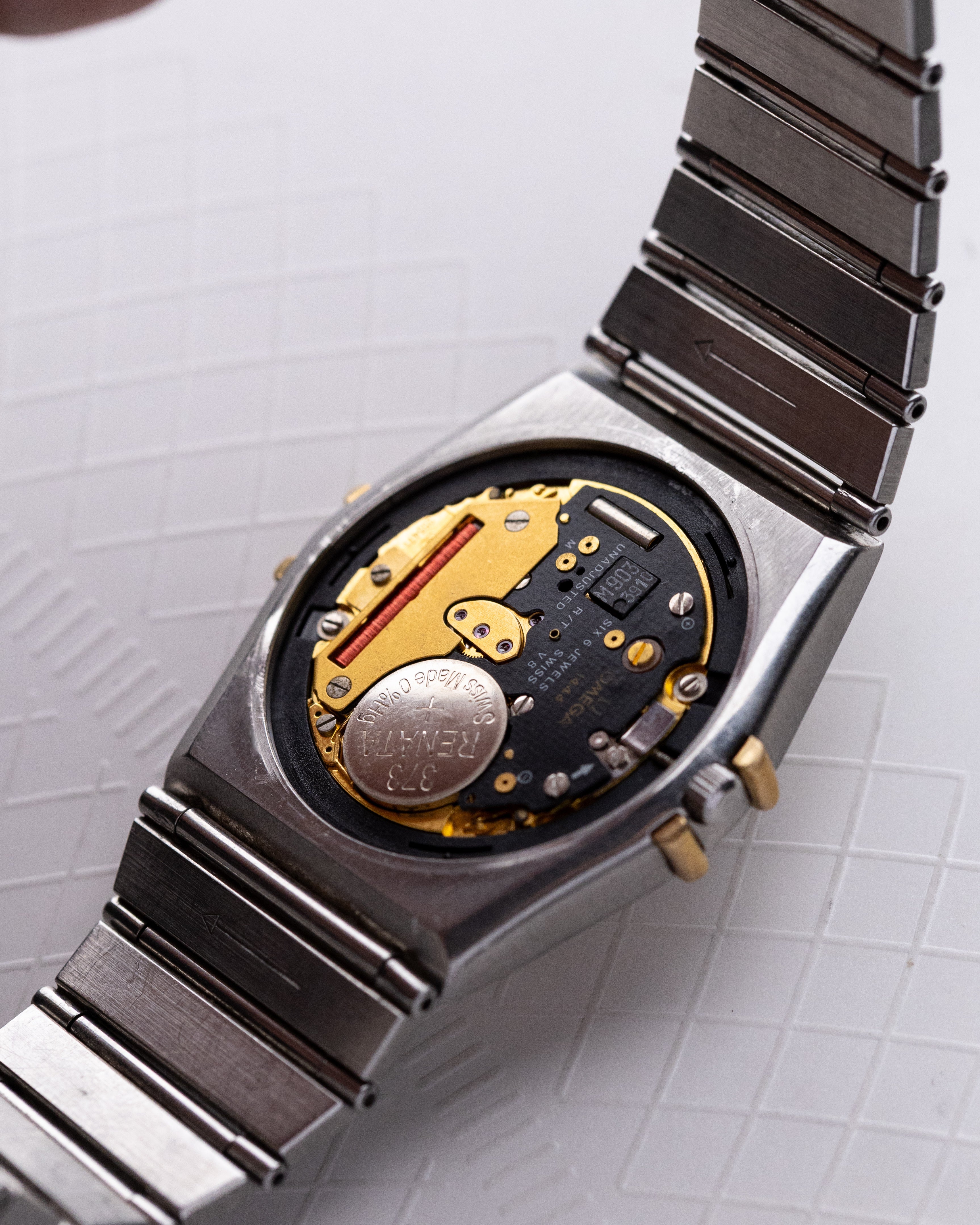 Vintage Omega Constellation Black Manhattan Day - Date, Solid Gold Bezel, Ref. DB 396.1070, Two - Tone Dial, Quartz Cal. 1444 from 1980s - DuMarko